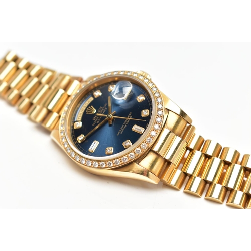 5 - AN 18CT YELLOW GOLD AND DIAMOND DAY-DATE ROLEX WRISTWATCH, the dark blue dial with diamond dot hourl... 