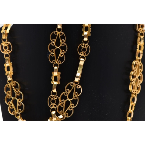 7 - A YELLOW METAL NECKLACE, designed as a series of openwork scrolling links with hook clasp, approxima... 