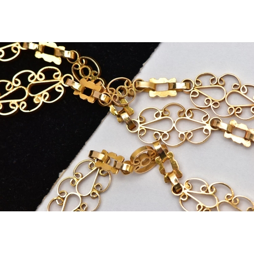 7 - A YELLOW METAL NECKLACE, designed as a series of openwork scrolling links with hook clasp, approxima... 