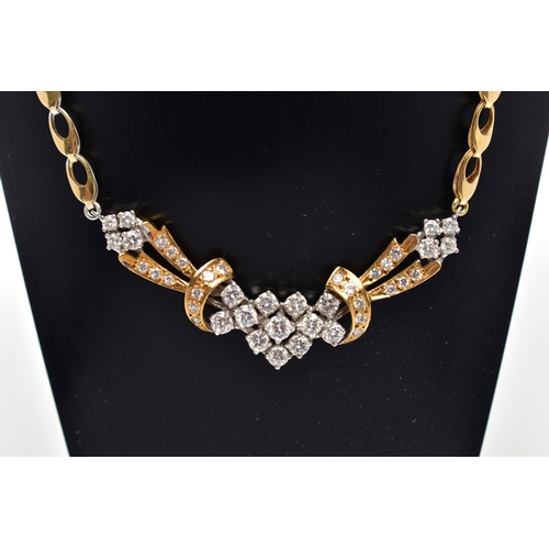 8 - A YELLOW AND WHITE METAL DIAMOND NECKLACE, the front designed as an openwork panel set throughout wi... 