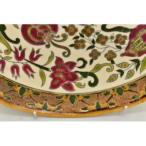 112 - A ZSOLNAY PECS POTTERY POLYCHROME ENAMELLED CHARGER, ochre rim surrounding a rough textured gilt and... 