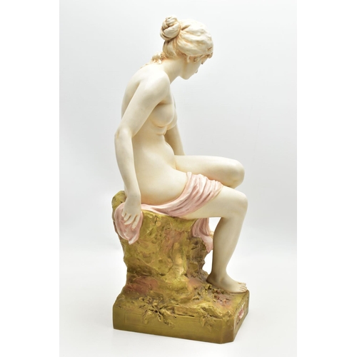 125 - AN EARLY 20TH CENTURY ROYAL DUX FIGURE OF A SEATED NUDE FEMALE BATHER, modelled on a rocky outcrop d... 