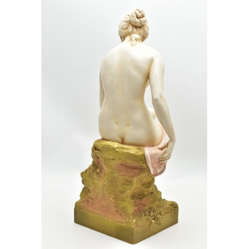 125 - AN EARLY 20TH CENTURY ROYAL DUX FIGURE OF A SEATED NUDE FEMALE BATHER, modelled on a rocky outcrop d... 