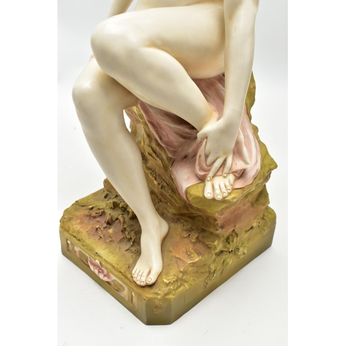 125 - AN EARLY 20TH CENTURY ROYAL DUX FIGURE OF A SEATED NUDE FEMALE BATHER, modelled on a rocky outcrop d... 