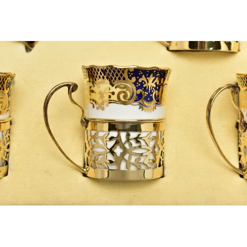 129 - A CASED SET OF SIX AYNSLEY COFFEE CANS IN SILVER GILT SLEEVES AND SIX SAUCERS, printed with a yellow... 