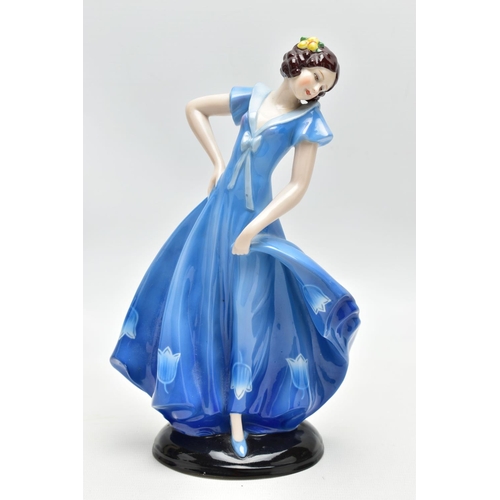 149 - A 1930'S CONTINENTAL PORCELAIN FIGURE OF A LADY IN A LONG BLUE DRESS, modelled standing on an oval b... 