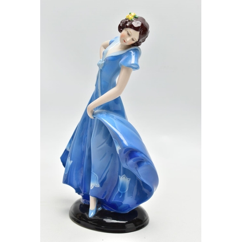 149 - A 1930'S CONTINENTAL PORCELAIN FIGURE OF A LADY IN A LONG BLUE DRESS, modelled standing on an oval b... 