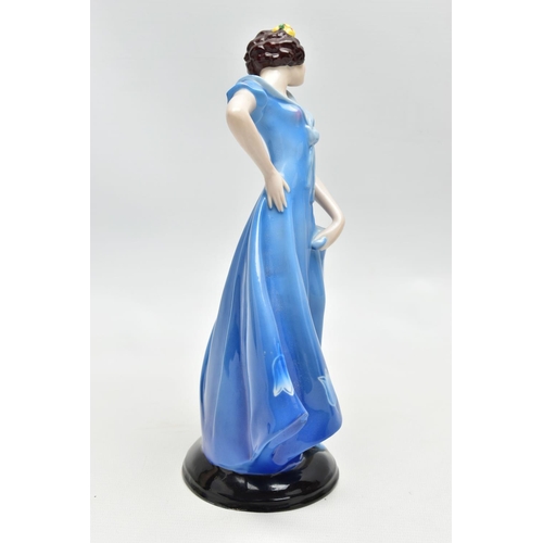 149 - A 1930'S CONTINENTAL PORCELAIN FIGURE OF A LADY IN A LONG BLUE DRESS, modelled standing on an oval b... 