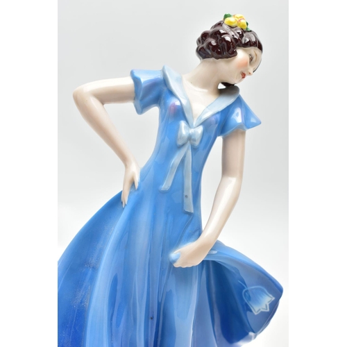 149 - A 1930'S CONTINENTAL PORCELAIN FIGURE OF A LADY IN A LONG BLUE DRESS, modelled standing on an oval b... 