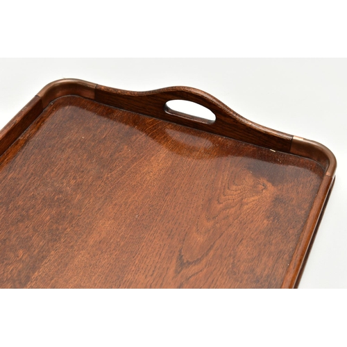 150 - AN EARLY 20TH CENTURY OAK TWIN HANDLED TRAY AND A VICTORIAN WALNUT WRITING SLOPE, the tray has four ... 