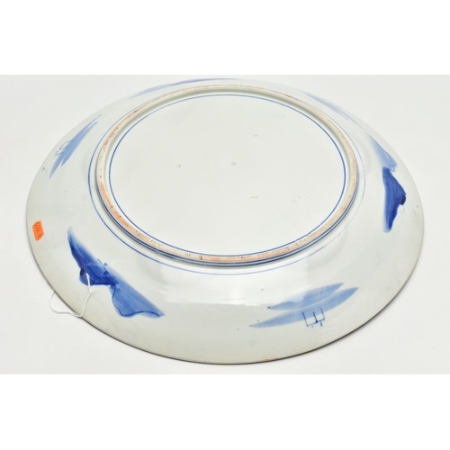 153 - A 19TH CENTURY JAPANESE PORCELAIN CHARGER, primarily painted in underglaze blue with a mountainous l... 