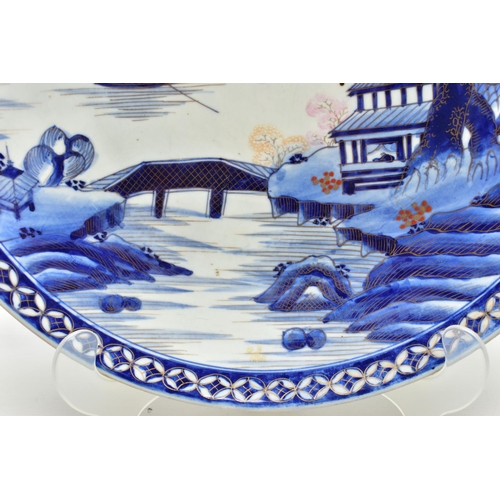 153 - A 19TH CENTURY JAPANESE PORCELAIN CHARGER, primarily painted in underglaze blue with a mountainous l... 