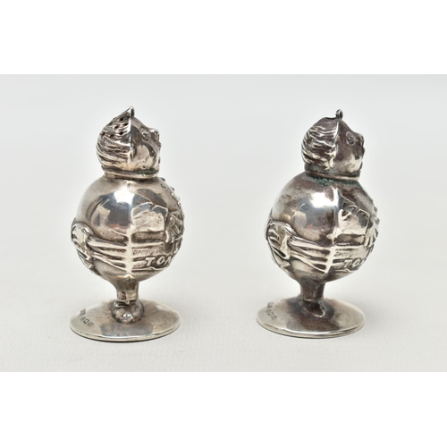 55 - A PAIR OF GEORGE V SILVER NOVELTY SALT AND PEPPER POTS IN THE FORM OF 'LITTLE TOM TUCKER', the head ... 