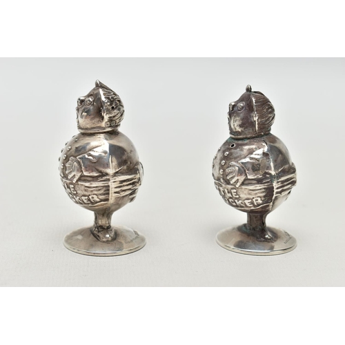 55 - A PAIR OF GEORGE V SILVER NOVELTY SALT AND PEPPER POTS IN THE FORM OF 'LITTLE TOM TUCKER', the head ... 