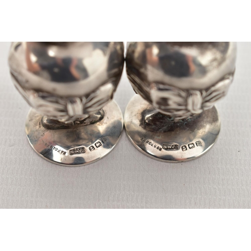 55 - A PAIR OF GEORGE V SILVER NOVELTY SALT AND PEPPER POTS IN THE FORM OF 'LITTLE TOM TUCKER', the head ... 