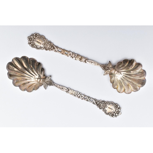 56 - A PAIR OF LATE VICTORIAN SILVER SERVING SPOONS, each with a shell shape bowl, floral and foliate dec... 