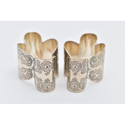 57 - A PAIR OF EDWARDIAN SILVER NAPKIN RINGS, two lobed designed napkin rings, detailed with floral engra... 