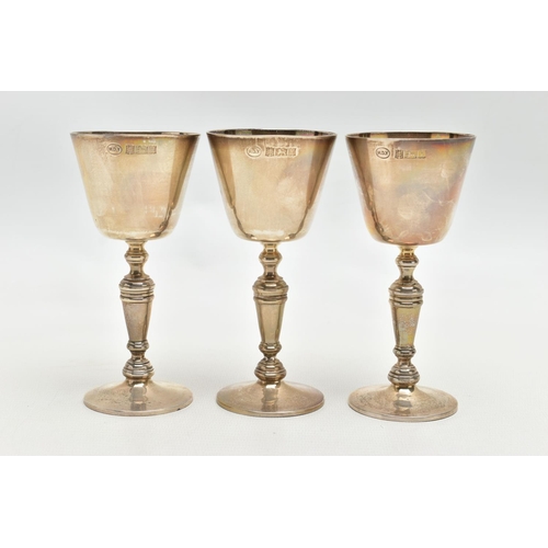 68 - A SET OF THREE ELIZABETH II SILVER GOBLETS, conical bowl on a baluster stem with a circular foot, ma... 