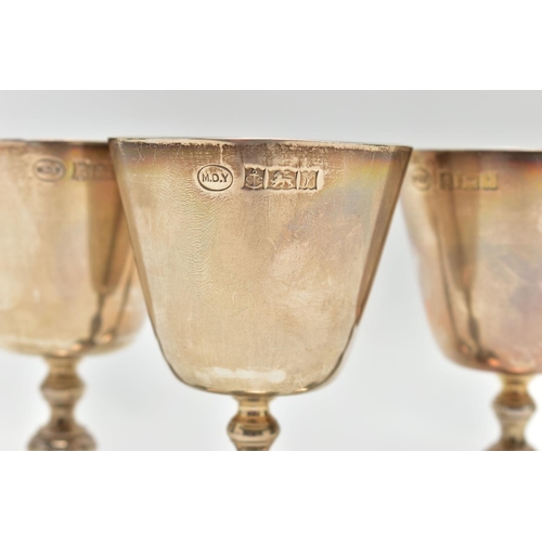 68 - A SET OF THREE ELIZABETH II SILVER GOBLETS, conical bowl on a baluster stem with a circular foot, ma... 