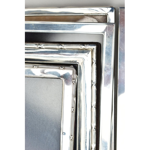 71 - TWELVE SILVER PHOTOGRAPH FRAMES AND TWO SMALL SILVER PLATED BOWLS, all of the photograph frames are ... 