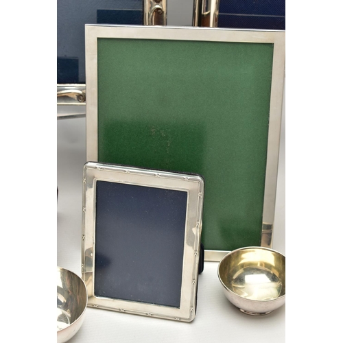 71 - TWELVE SILVER PHOTOGRAPH FRAMES AND TWO SMALL SILVER PLATED BOWLS, all of the photograph frames are ... 