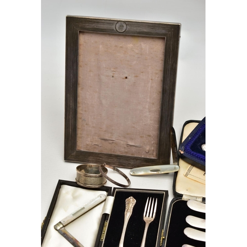 75 - A GROUP OF CASED AND LOOSE SILVER, comprising a rectangular photograph frame, engine turned decorati... 