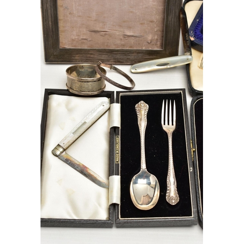 75 - A GROUP OF CASED AND LOOSE SILVER, comprising a rectangular photograph frame, engine turned decorati... 