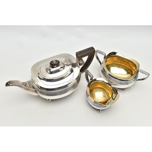 78 - AN EDWARDIAN SILVER THREE PIECE SHAPED RECTANGULAR TEA SERVICE OF LATE GEORGIAN STYLE, horizontal re... 