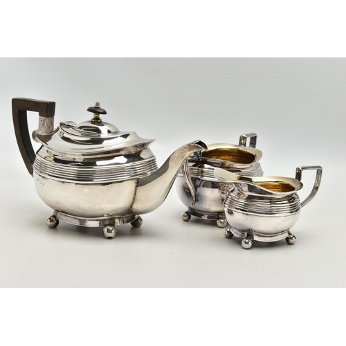 78 - AN EDWARDIAN SILVER THREE PIECE SHAPED RECTANGULAR TEA SERVICE OF LATE GEORGIAN STYLE, horizontal re... 