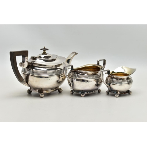 78 - AN EDWARDIAN SILVER THREE PIECE SHAPED RECTANGULAR TEA SERVICE OF LATE GEORGIAN STYLE, horizontal re... 