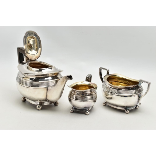 78 - AN EDWARDIAN SILVER THREE PIECE SHAPED RECTANGULAR TEA SERVICE OF LATE GEORGIAN STYLE, horizontal re... 