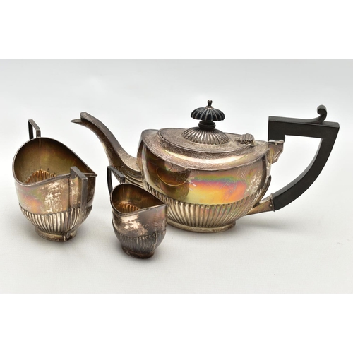 83 - A GEORGE V SILVER THREE PIECE BACHELOR'S TEA SET OF OVAL FORM, the tea pot with ebonised fitments, a... 