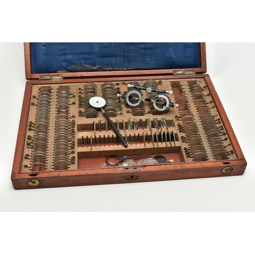 168 - AN EARLY 20TH CENTURY MAHOGANY CASED OPTOMETRIST SET, the interior fitted with a selection of lenses... 