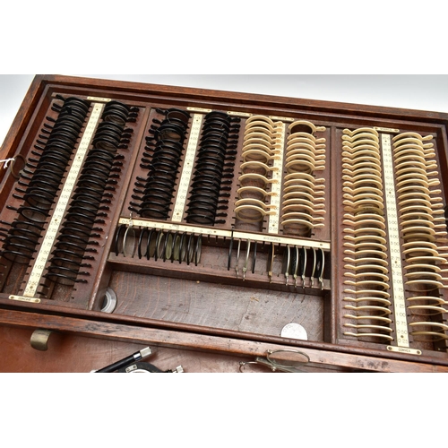 168 - AN EARLY 20TH CENTURY MAHOGANY CASED OPTOMETRIST SET, the interior fitted with a selection of lenses... 