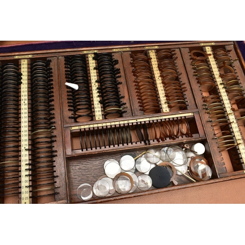 168 - AN EARLY 20TH CENTURY MAHOGANY CASED OPTOMETRIST SET, the interior fitted with a selection of lenses... 