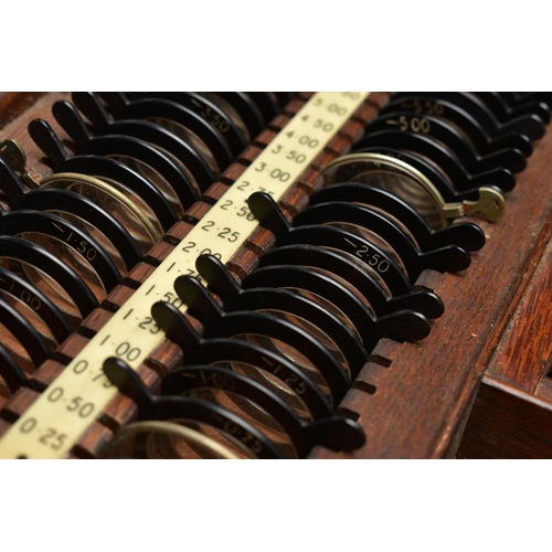 168 - AN EARLY 20TH CENTURY MAHOGANY CASED OPTOMETRIST SET, the interior fitted with a selection of lenses... 