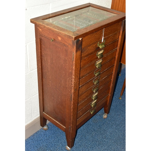 170 - OPTOMETRIST INTEREST: AN EARLY 20TH CENTURY RECTANGULAR OAK CABINET WITH GLAZED CASE ABOVE NINE DRAW... 