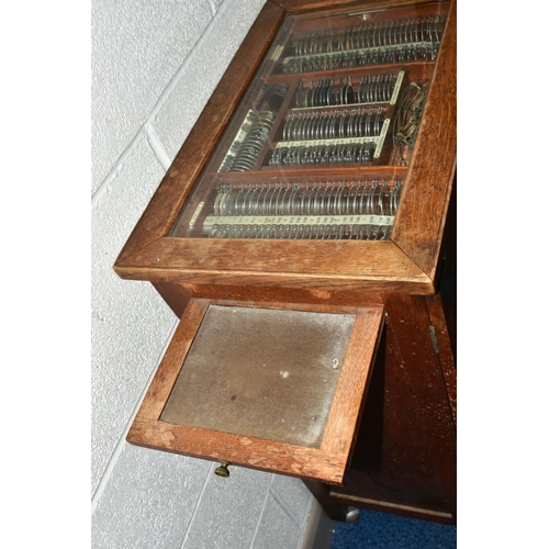 170 - OPTOMETRIST INTEREST: AN EARLY 20TH CENTURY RECTANGULAR OAK CABINET WITH GLAZED CASE ABOVE NINE DRAW... 