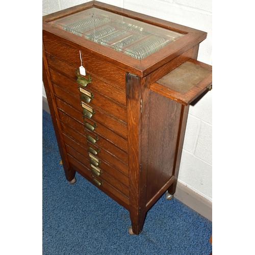 170 - OPTOMETRIST INTEREST: AN EARLY 20TH CENTURY RECTANGULAR OAK CABINET WITH GLAZED CASE ABOVE NINE DRAW... 