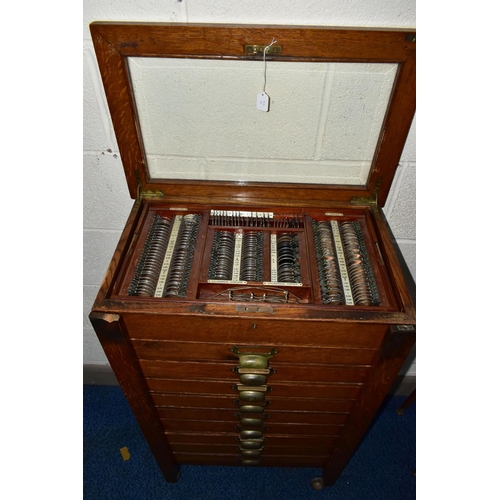 170 - OPTOMETRIST INTEREST: AN EARLY 20TH CENTURY RECTANGULAR OAK CABINET WITH GLAZED CASE ABOVE NINE DRAW... 