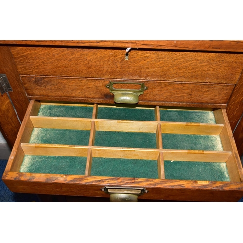 170 - OPTOMETRIST INTEREST: AN EARLY 20TH CENTURY RECTANGULAR OAK CABINET WITH GLAZED CASE ABOVE NINE DRAW... 