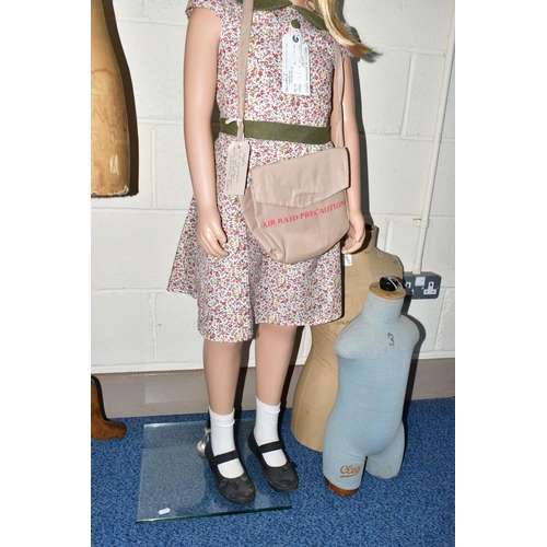 172 - A SECOND HALF 20TH CENTURY YOUNG GIRL PLASTIC SHOP MANNEQUIN ON A GLASS BASE, dressed as a 1940's ev... 