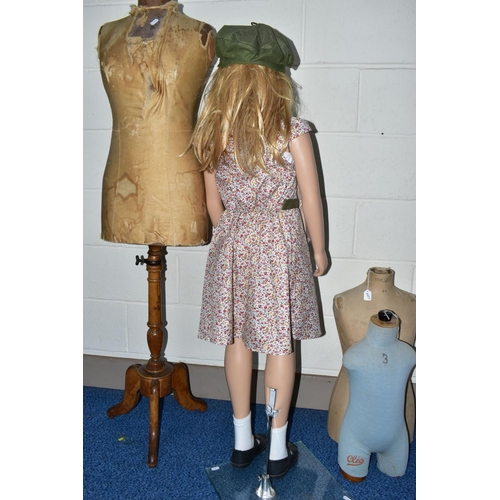 172 - A SECOND HALF 20TH CENTURY YOUNG GIRL PLASTIC SHOP MANNEQUIN ON A GLASS BASE, dressed as a 1940's ev... 