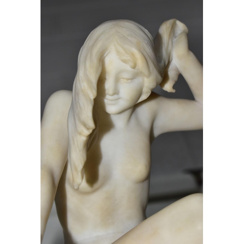 174 - A 20TH CENTURY CARVED ALABASTER FIGURE OF A FEMALE NUDE BATHER SEATED ABOVE A WATERFALL, formed of t... 