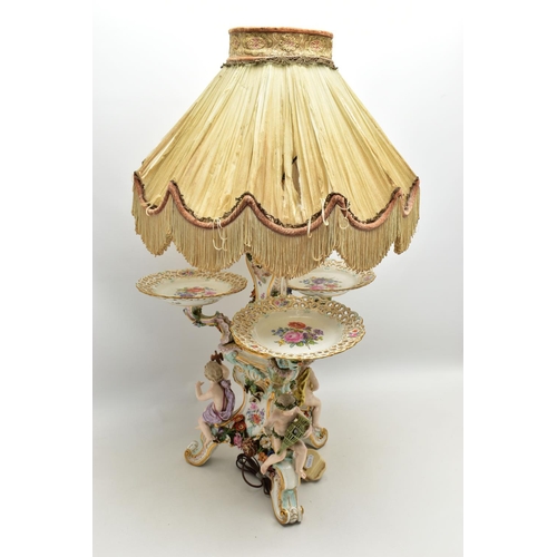 176 - A LATE 19TH CENTURY MEISSEN FIGURAL AND FLORAL ENCRUSTED CENTREPIECE ADAPTED TO A TABLE LAMP, the la... 