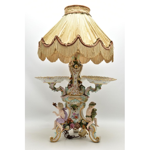 176 - A LATE 19TH CENTURY MEISSEN FIGURAL AND FLORAL ENCRUSTED CENTREPIECE ADAPTED TO A TABLE LAMP, the la... 