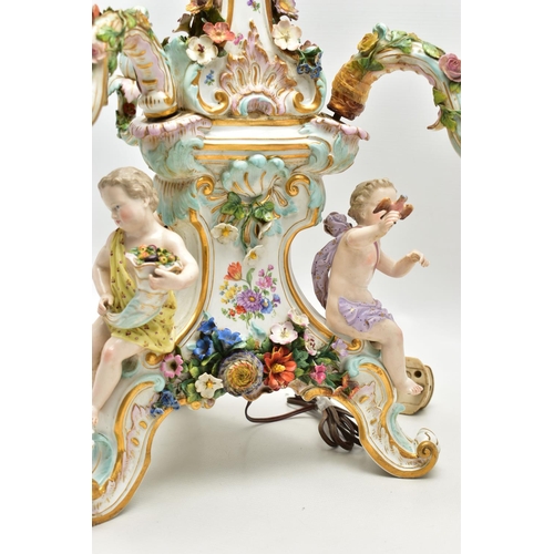 176 - A LATE 19TH CENTURY MEISSEN FIGURAL AND FLORAL ENCRUSTED CENTREPIECE ADAPTED TO A TABLE LAMP, the la... 