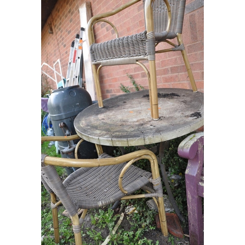 1005 - A HEAVY METAL FRAME CIRCULAR GARDEN TABLE  with a mineral effect top 90cm in diameter along with a p... 