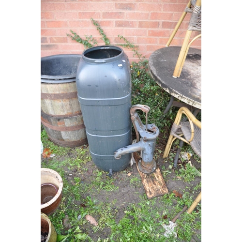 1006 - A VINTAGE CAST IRON WATER PUMP mounted on a distressed plywood plinth 57cm high along with a plastic... 