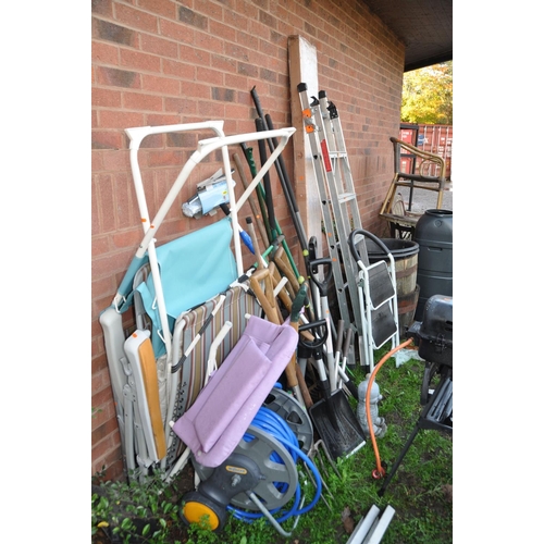 1008 - A LARGE QUANTITY OF GARDEN TOOLS AND FURNITURE including a boxed and unopened barbecue shelter, step... 